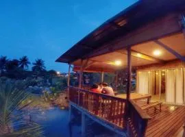 Tung's Tropika - With a Wooden Hut by a Lake