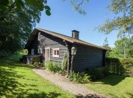 Open wooden chalet built against a hill