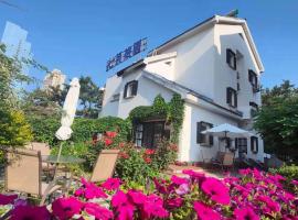 威海七月花园客栈(海水浴场火炬8街店)，位于威海的酒店