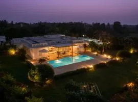 Whispering Palms by StayVista - Pool-view villa with Boutique interiors, Terrace & Lawn