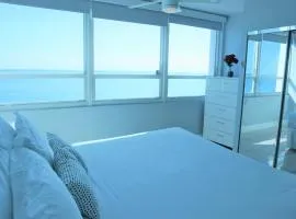 Oceanfront condo with ocean view beach, bar, free parking and gym!