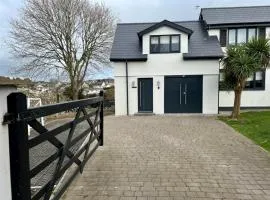Orchard Lodge -Coastal Retreat, new build, village views, private garden and terrace