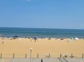 Oceanfront beach, sky, & dolphins