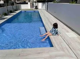 Beach bungalow with swiming pool and long terrace