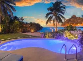 Oceanfront villa with private beach, heated pool, tiki and boat dock