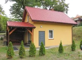 Cottage with fireplace, right on the lake, Ryn