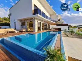 Villa Ramarin 1 with heated pool, jacuzzi and sauna by the sea in Rogoznica