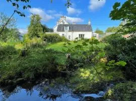 Traditional farm cottage with woodburner by stream