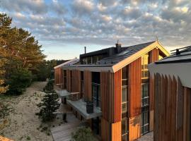 "Nidos vėtrungės" atostogų namai，位于奈达的酒店