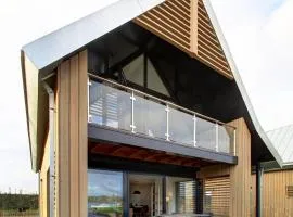 Modern design lodge on the water located on a holiday park in a national park