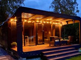A tiny house with a garden and a hot tube