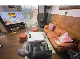 Tatami room & Living Room equipped with Multinational TV and Fire, BBQ corner in Tokyo Downtown House