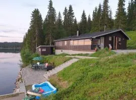 Idyllic lakeside cabin with private beach and boat