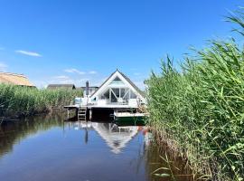 Seehütte Neusiedlersee - Strandhaus, Elektroboot inklusive，位于拉斯特的木屋