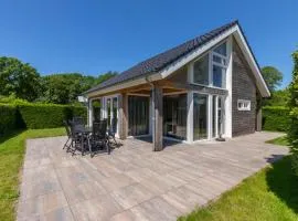 Detached holiday home in a wooded area near the beach