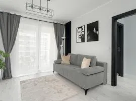 Wyjątkowy i Nowoczesny Apartament z Balkonem i Parkingiem by Noclegi Renters