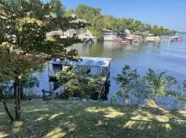 Cozy Cabin Lake Home dock slip and water toys