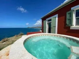 Honeymoon Cottage Atop a rocky peninsula surrounded by the Caribbean Sea