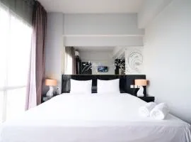 Homey Studio No Kitchen at Grand Darmo Suite Apartment By Travelio