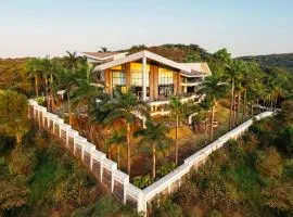 StayVista's Emerald Acres offering a heated pool, bonfire, snooker table, scenic views, tennis court, steam room, gazebo, & gym