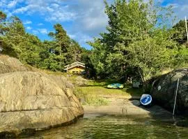 Seaside cabin with boat and beach in Kragerø
