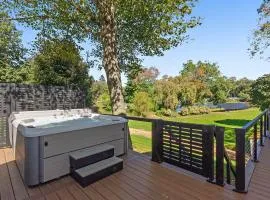 Modern Waterfront Retreat with Hot Tub & Pond Views