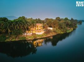 StayVista at Maison Vera with Pool, River front view，位于瓦塞的酒店