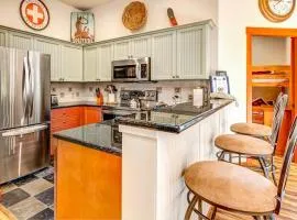 ski-in - ski-out condo with a deck ski views & a shared pool and hot tub