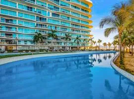 Luxury ocean-view condo with resort pool, private balcony, and washer/dryer