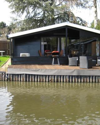 Modern chalet in a small park with a fishing pond