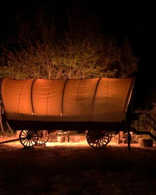 Cozy Wild West Covered Wagon next to River