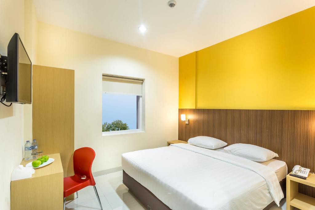 塞尔蓬宾塔罗阿斯特拉酒店的一间卧室设有一张床和黄色的墙壁