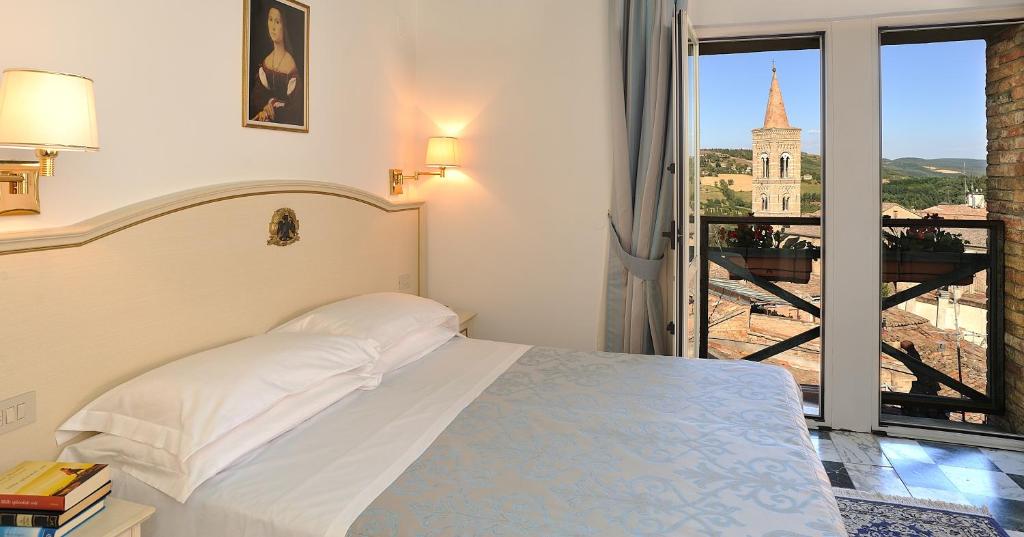 乌尔比诺Hotel Raffaello - Self Check-in Free的一间卧室配有一张床,享有建筑的景色