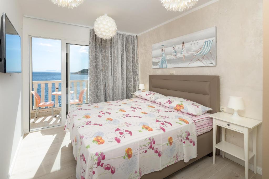 赫瓦尔Superb Beachfront Luxury Seaview with Private Beach的一间卧室设有一张床和一个阳台