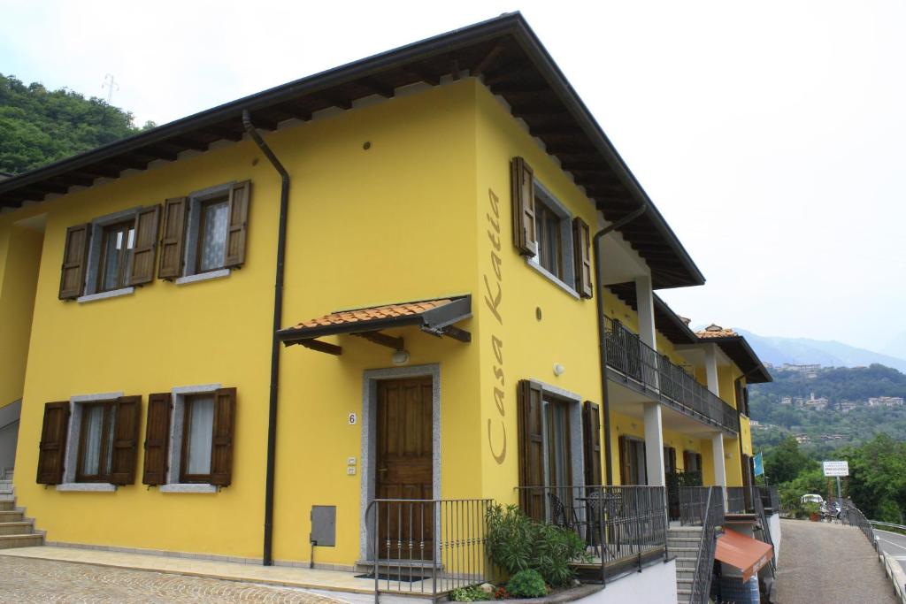 特雷莫西内Appartamenti Katia的黑色屋顶的黄色房子