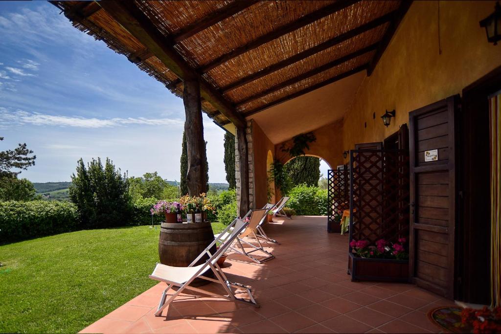 萨杜勒尼亚B&B 8380 Saturnia Terme的一个带草坪椅的庭院和一座建筑