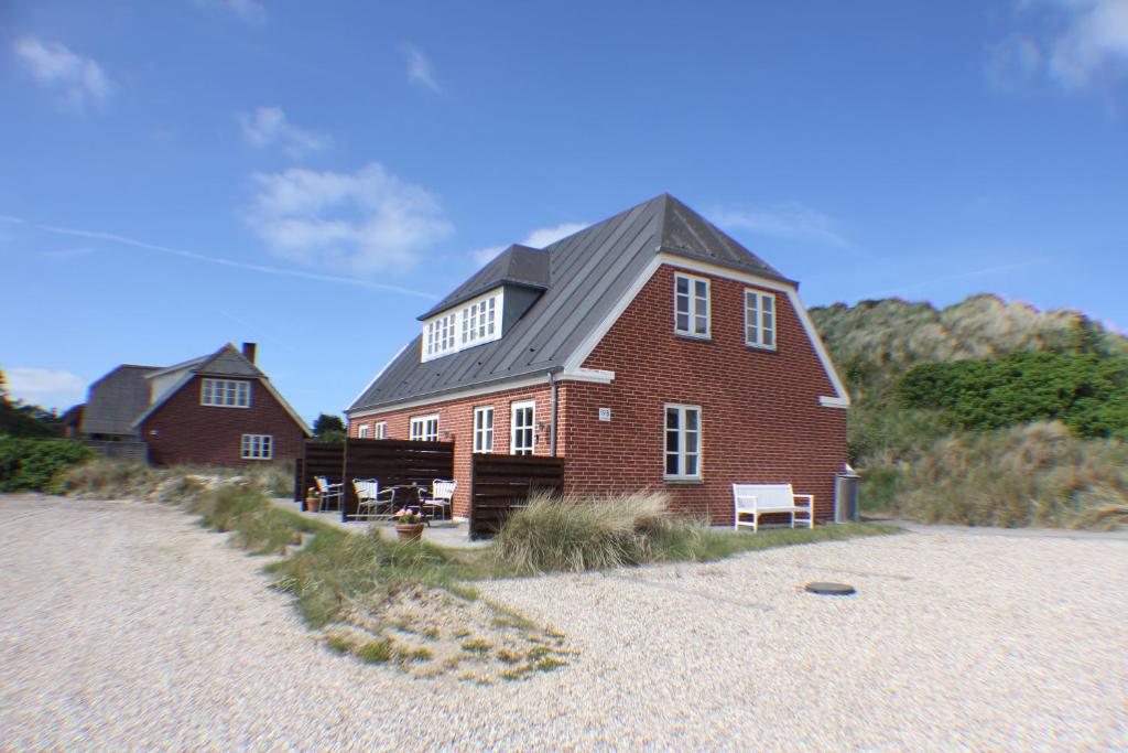 亨讷斯特兰德Klitgaarden Henne Strand的海滩上一座大型红砖房子