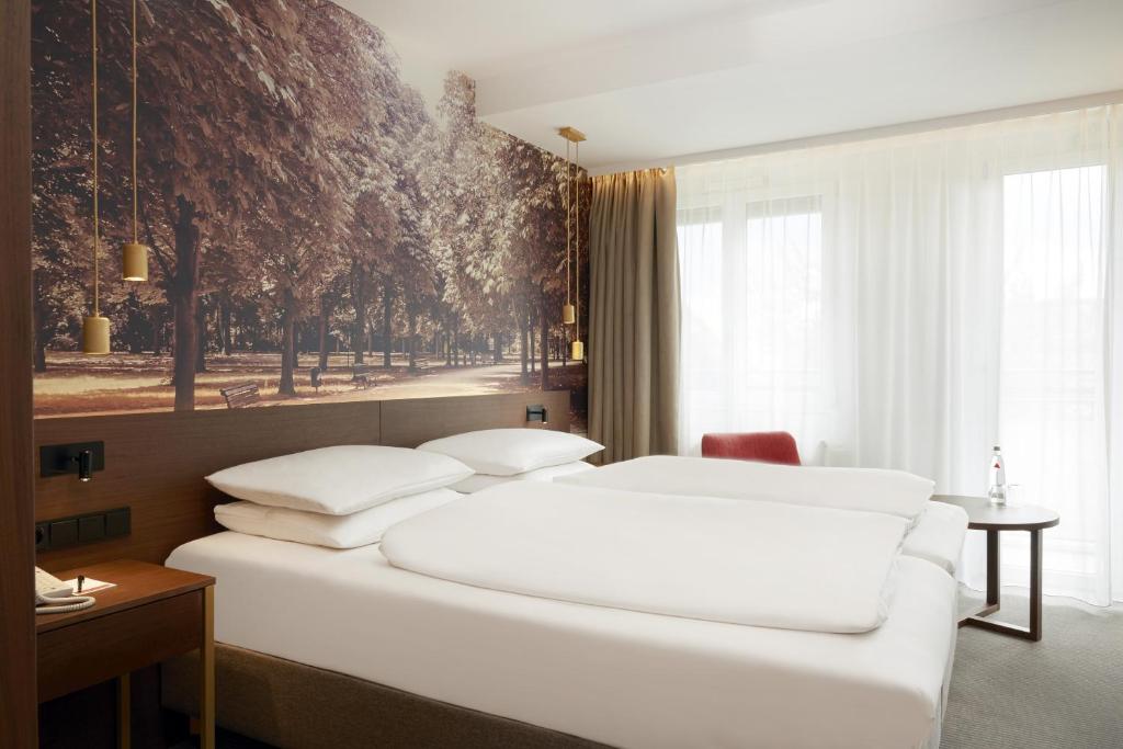 柏林HYPERION Hotel Berlin的卧室设有一张白色大床和一扇窗户。