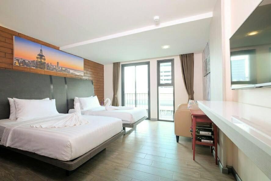 曼谷科隆谭的酒店客房配有两张床和一张书桌