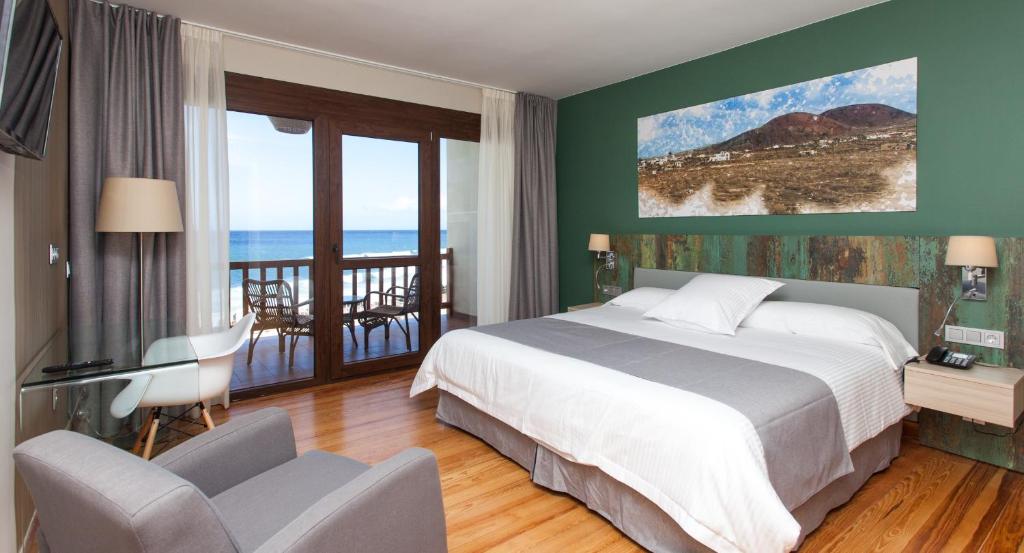 罗萨里奥港Hotel El Mirador de Fuerteventura的一间卧室配有一张床,享有海景