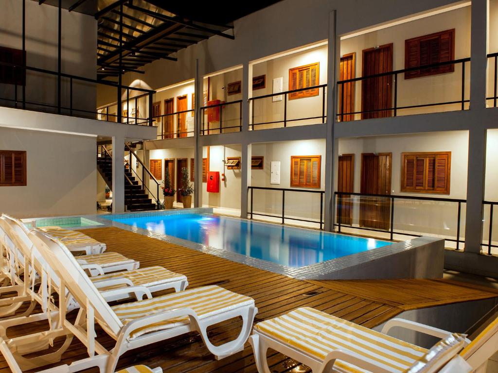 博尼图CLH Suites Bonito Centro的一个带躺椅的游泳池和一个游泳池