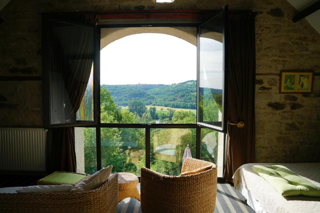 喀斯和迭日Hôtel Restaurant Le Mûrier de Viels - Figeac Grand的一间卧室设有美景大窗户