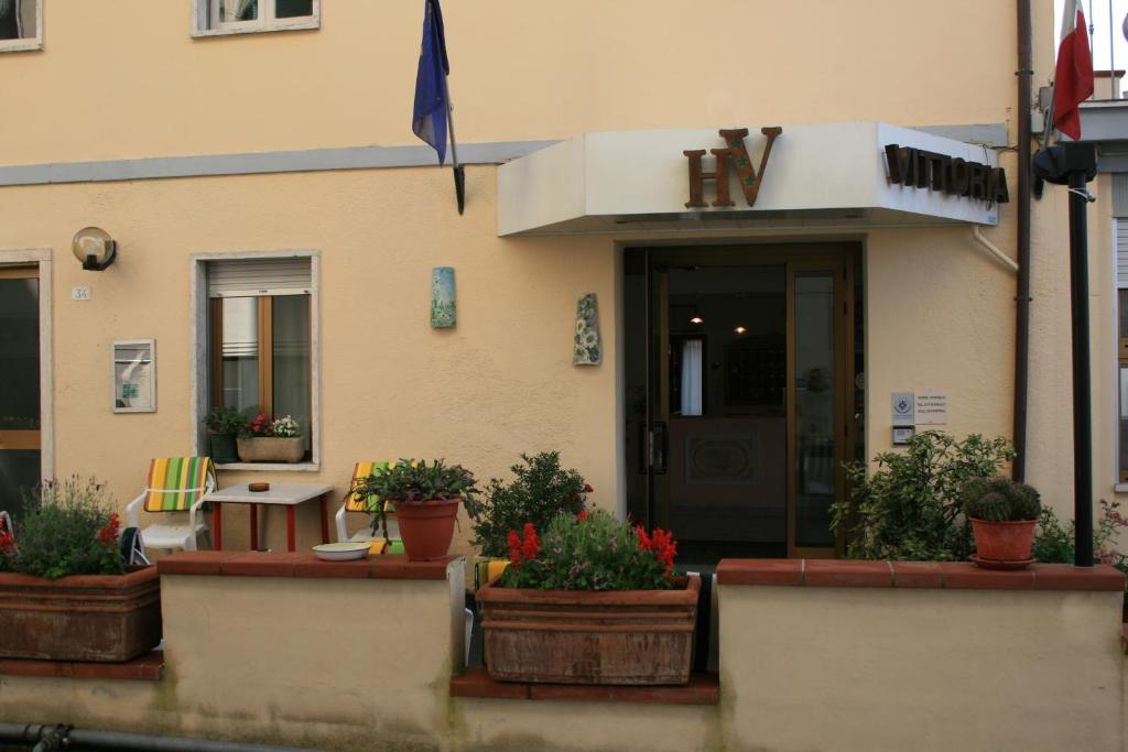 基安奇安诺泰尔梅Hotel Vittoria的前面有盆栽植物的建筑