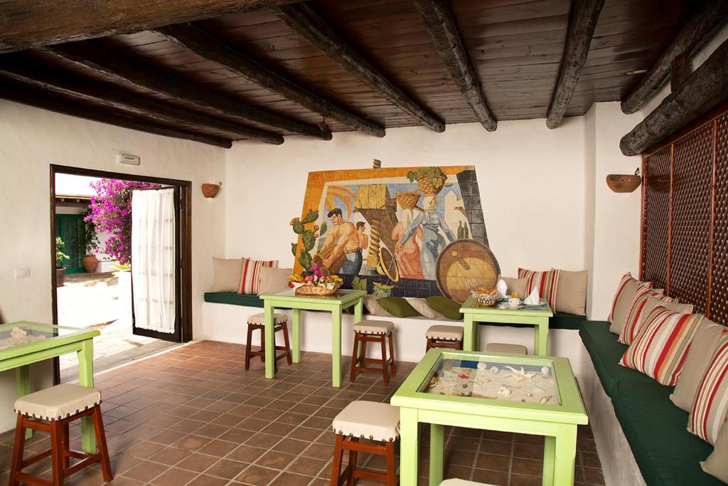 亚伊萨Hotelito La Era B&B的一间设有桌子的房间和墙上的绘画