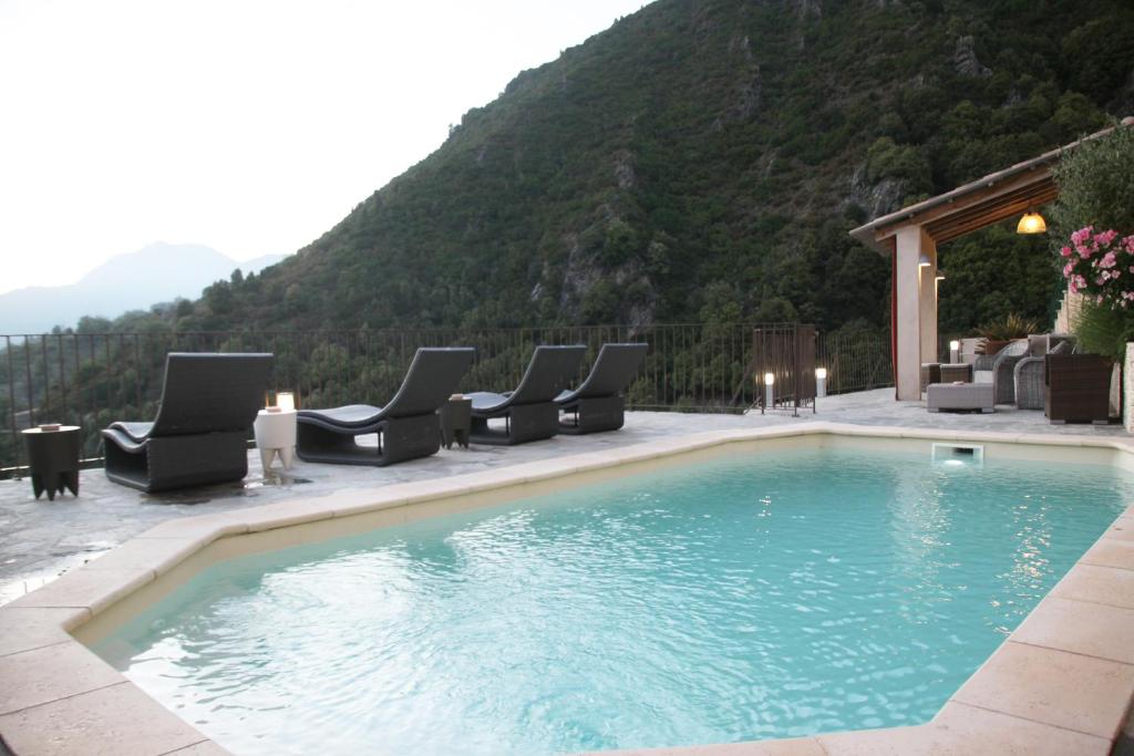 马佐拉Casa Di Lucia Mi-Hotel的一个带躺椅的游泳池和一个山