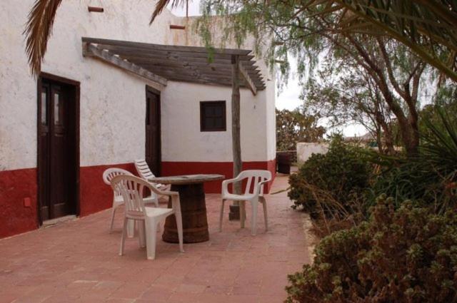 拉奥利瓦GBH Casas Las Portadas的一个带桌椅的庭院和一座建筑