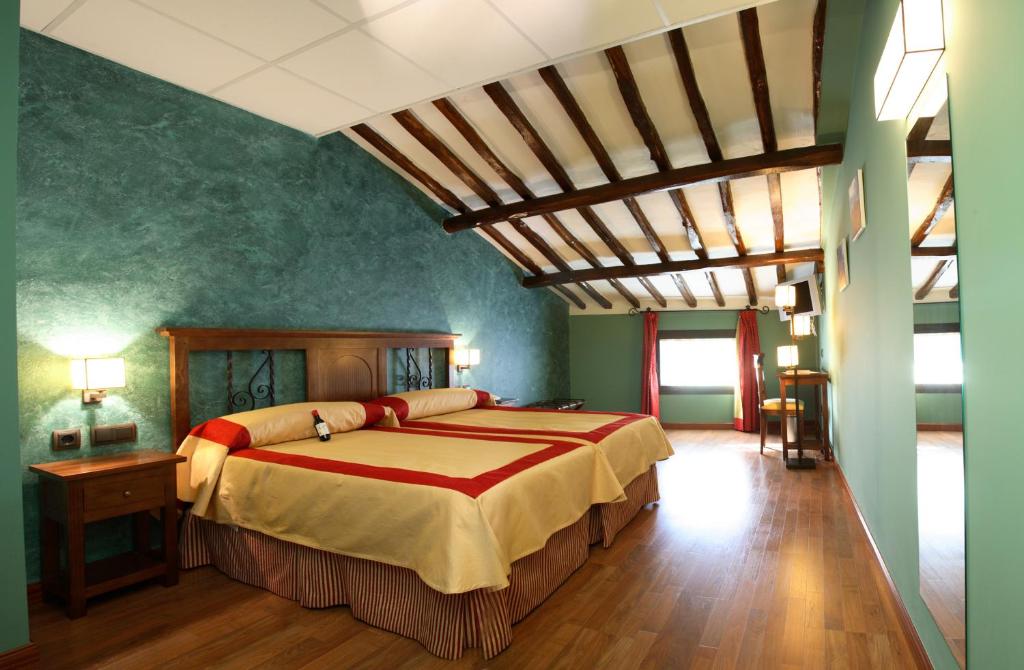 纳赫拉纳胡拉公爵酒店的一间设有一张大床的卧室,位于带绿色墙壁的房间