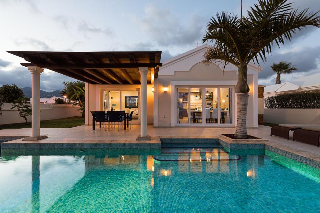 卡门港Villas Alondra的一座带游泳池和房子的别墅