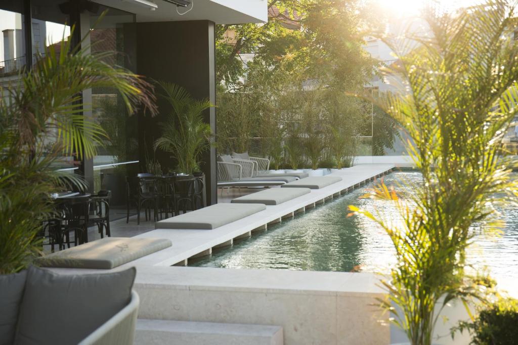 里斯本王储花园梅莫设计酒店的一个带桌椅的度假村游泳池
