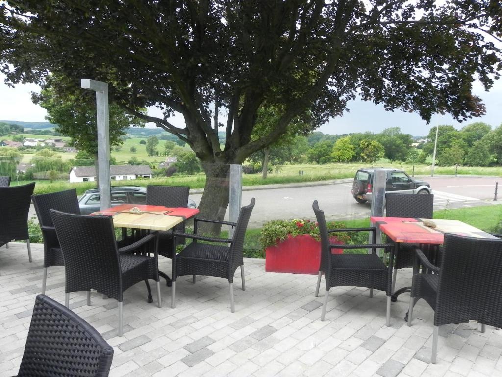 费伦德孔斯特酒店 - 餐厅的庭院配有桌椅和一棵树